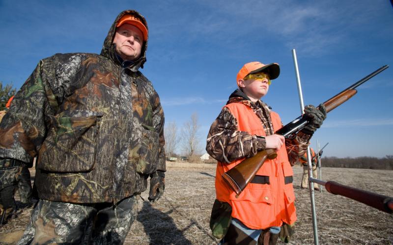 a veteran hunter mentors a young hunter in the field