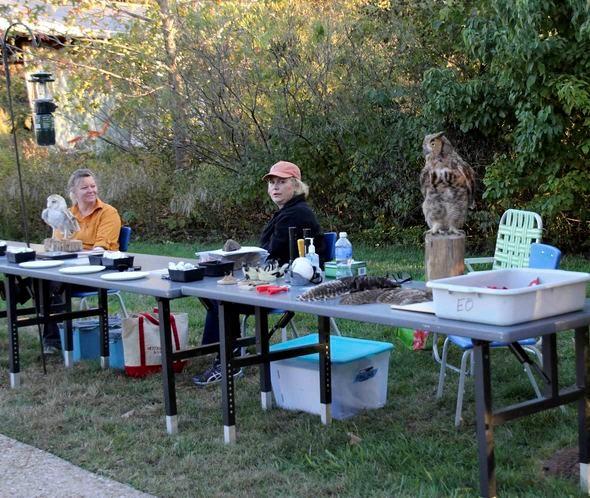 MDC volunteers sit at an informational booth on Missouri's native owls.