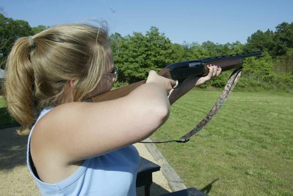 woman shooting shotgun