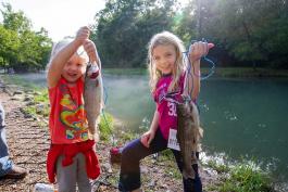 Two young girls reap the benefits of the stocking program by catching trout