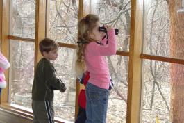 Kids looking through binoculars at Powder Valley