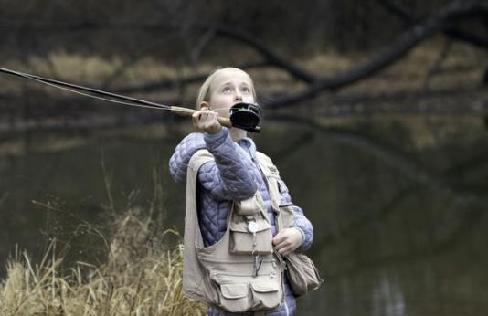 Young girl fly fishing