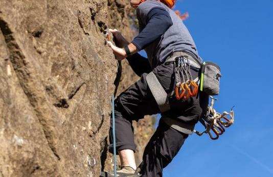 A man rock climbs at Rockwoods Reservation