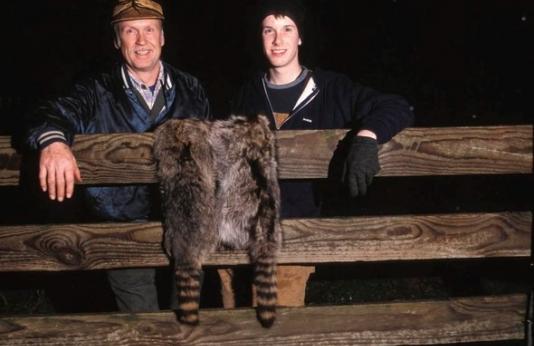 two raccoon hunters with pelts
