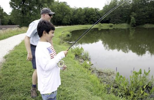 Sam Stewart fishing with boy