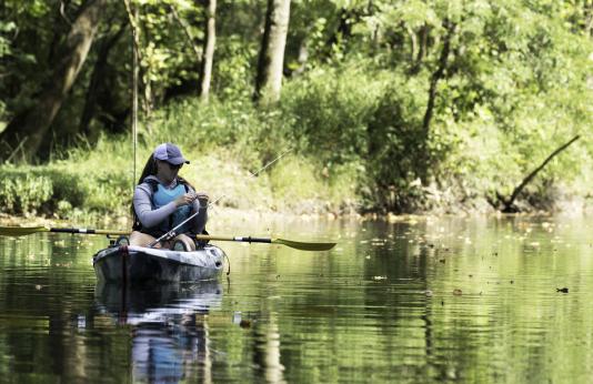 woman fishing from kayak