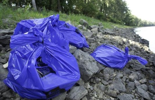 Stream Team trash bags along river following clean-up efforts