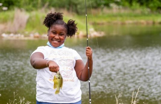 Young girl holds bluegill