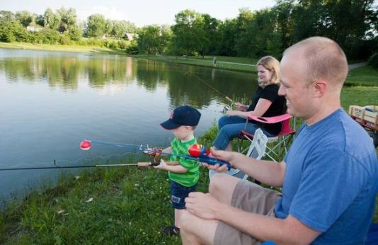 A family fishing from a pond