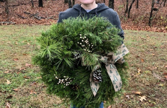 Girl holds holiday wreath