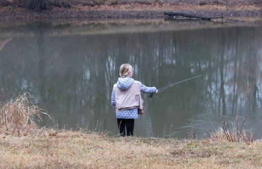 Girl fishing in winter