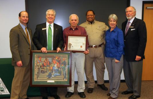 Hunter Ed winner Floyd Bohler with director and commissioners 