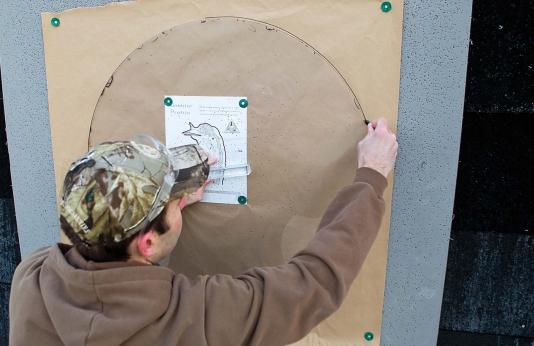 A shooter evaluates his pattern on a turkey-shaped target