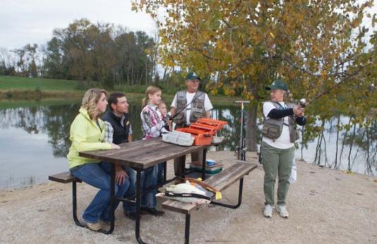 MDC staff gives family a fishing instruction.