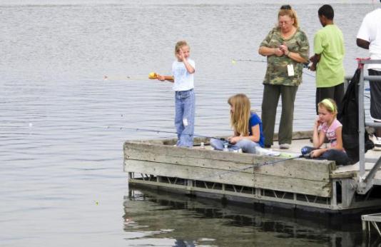 A family fishes off a dock at Little River conservation area