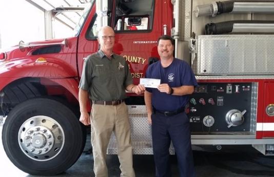MDC Forestry Technician Duane Petzoldt delivered a grant check for $3,000 to Treasurer and Assistant Chief Kelly Allen at the East Cape County Fire Protection District. 