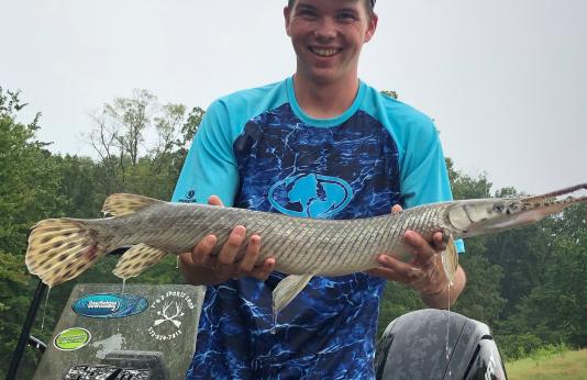 Mitchell Dering poses with his record-breaking spotted gar.