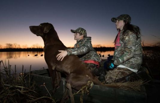 Youth waterfowl hunting with dog