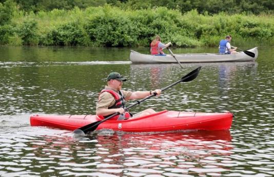 An MDC staff member kayaks on a lake.