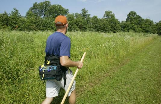 man hiking in field