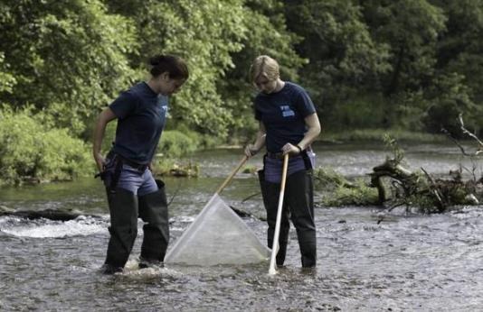 two volunteers monitor water quality in a Missouri stream