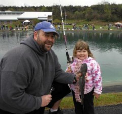 A young girl and her dad show off a great catch.